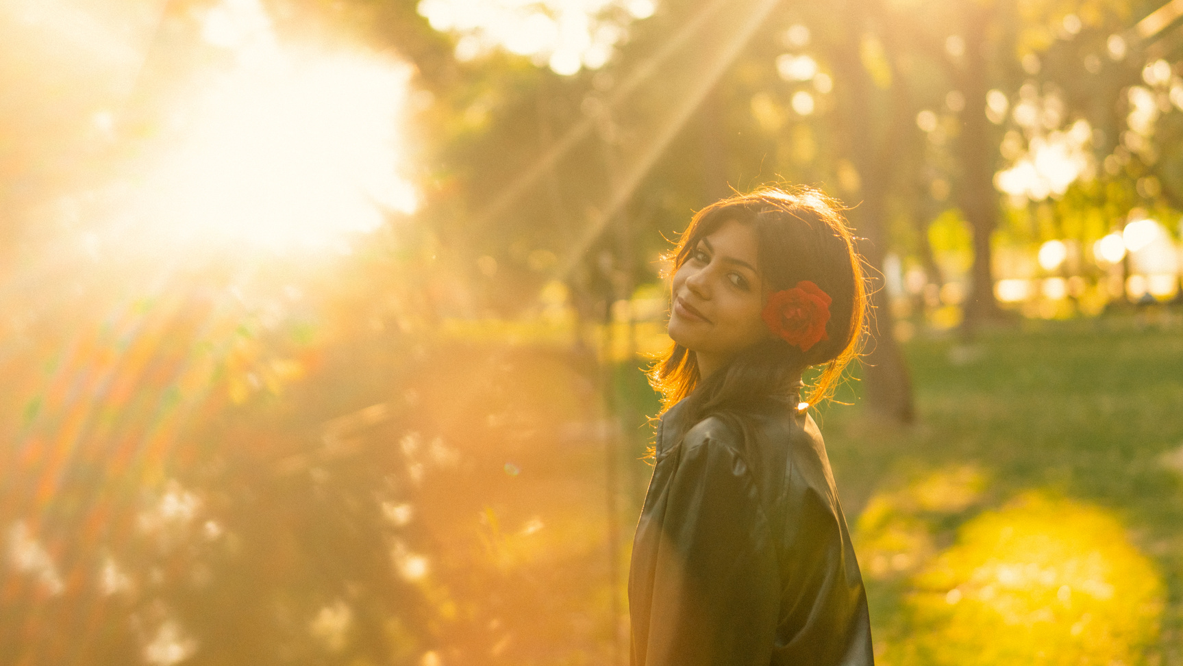Woman in Black Jacket Standing Under Sun Rays